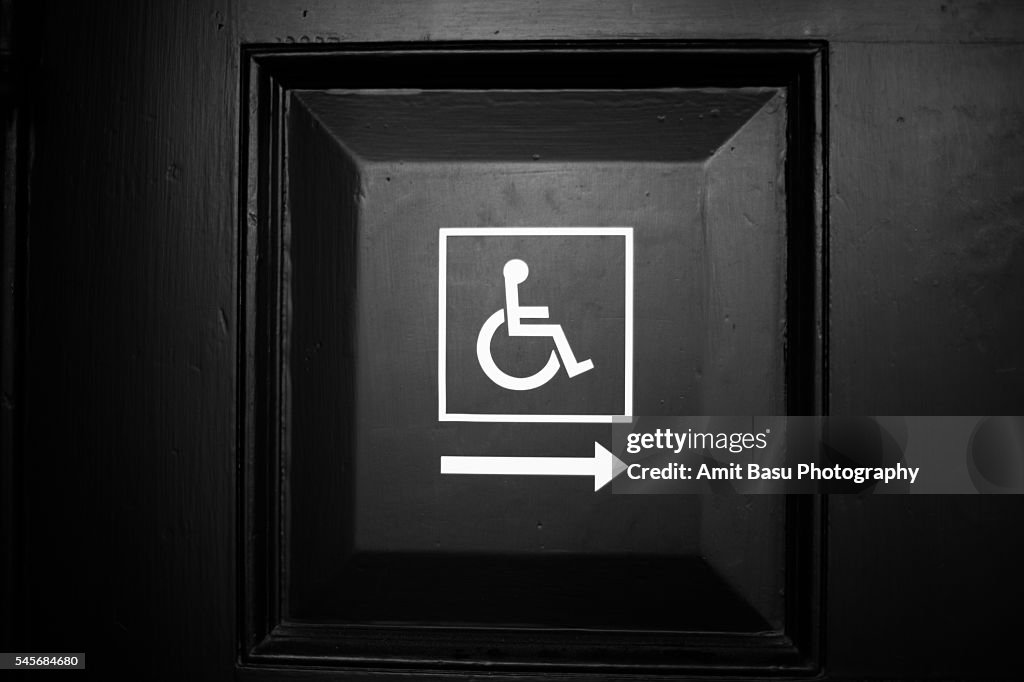 Handicapped wheelchair access sign on dooor
