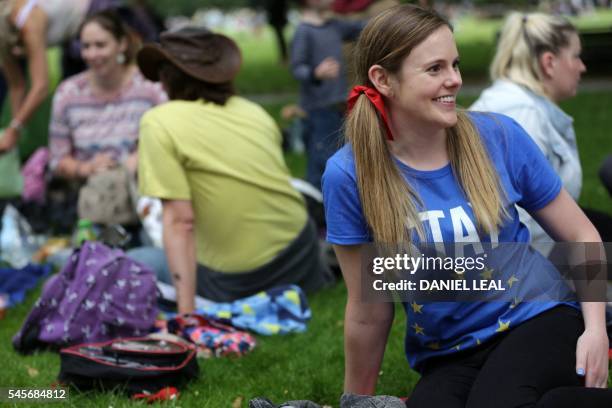 Woman wearing a "Stay" T-shirt smiles during a picnic against Brexit organised by the General Assembly in Green Park in London on July 9, 2016. - The...