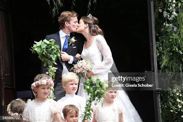 Bridegroom Franz-Albrecht zu Oettingen-Spielberg and his wife Cleopatra zu Oettingen-Spielberg kiss after the wedding of hereditary Prince...
