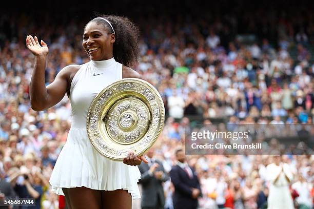 Serena Williams of The United States holds the trophy following victory in The Ladies Singles Final against Angelique Kerber of Germany on day twelve...
