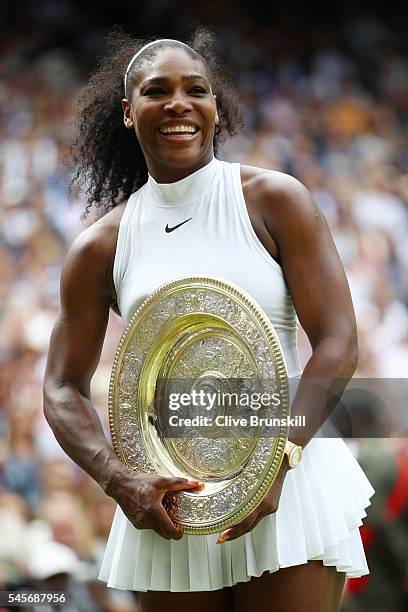 Serena Williams of The United States holds the trophy following victory in The Ladies Singles Final against Angelique Kerber of Germany on day twelve...