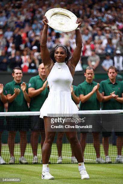 Serena Williams of The United States lifts the trophy following victory in The Ladies Singles Final against Angelique Kerber of Germany on day twelve...