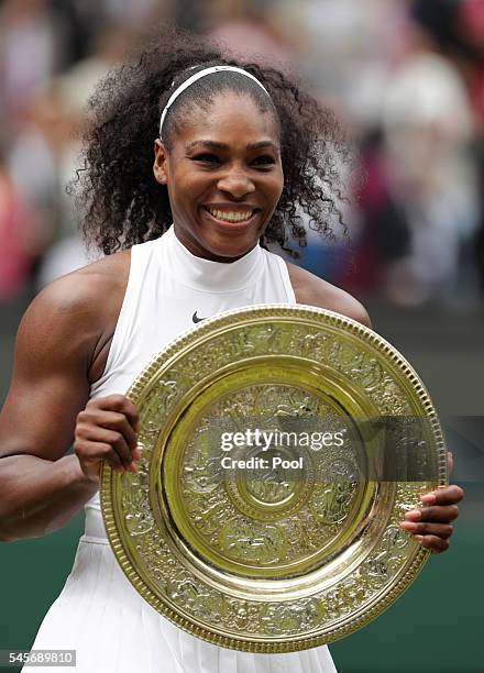 Serena Williams of The United States lifts the trophy following victory in The Ladies Singles Final against Angelique Kerber of Germany on day twelve...