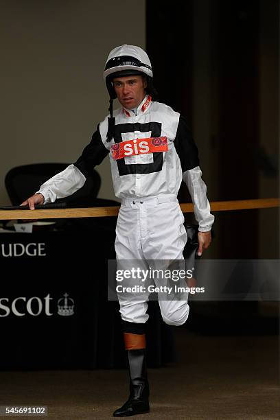 Timmy Murphy stretches before heading out to ride in The Playboy Club London Handicap Stakes Race run at Ascot Racecourse on July 9, 2016 in Ascot,...