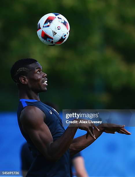 Paul Pogba heads the ball during a France training session on the eve of the UEFA EURO 2016 Final against Portugal at Clairefontaine on July 9, 2016...