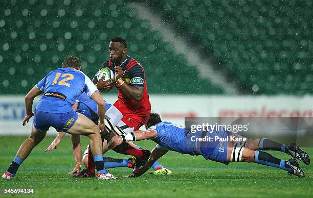 Siya Kolisi of the Stormers looks to avoid being tackled by Kyle Godwin and Richard Hardwick of the Force during the round 16 Super Rugby match...