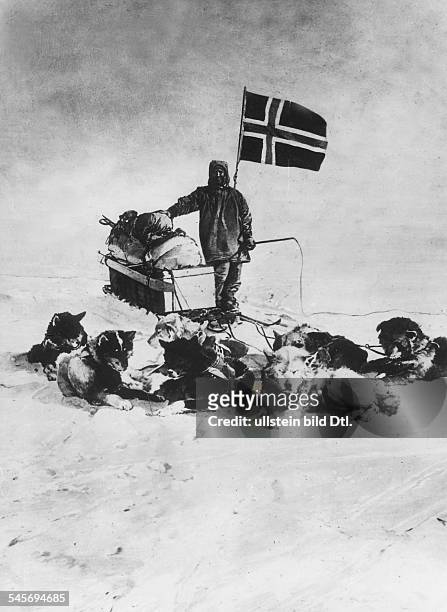 Norwegian polar explorer hoisting the Norwegian flag at the South Pole - December 14, 1911