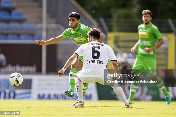 Mahmoud Dahoud of Borussia Moenchengladbach challenges Sebastian Gaertner of SV Waldhof Mannheim during the friendly match between SV Waldhof...