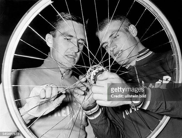 Junkermann, Hans *-Racing cyclist, Germanywith Rudi Altig regarding a rim.- 1961
