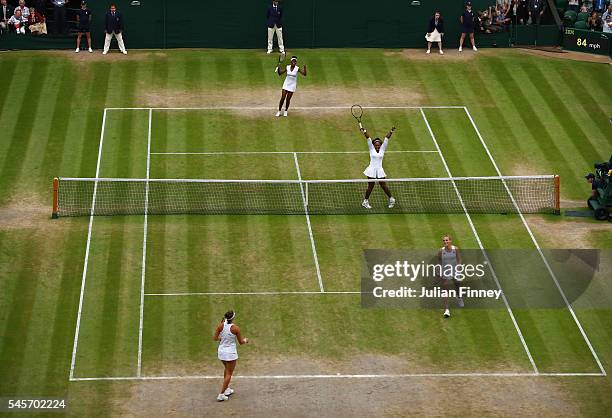 Venus Williams of The United States and Serena Williams of The United States celebrate victory in the Ladies Doubles Final against Timea Babos of...
