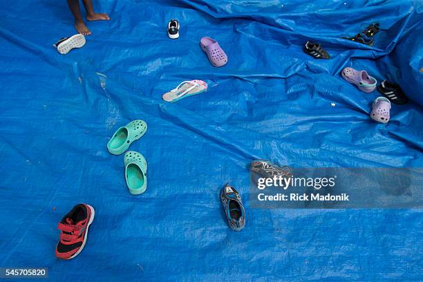 One youngster waits a turn inside the bounce castle, where shoes had to be removed before entering. The community where Lucent Ross who died from a...