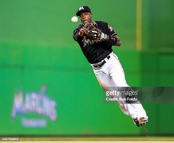Adeiny Hechavarria of the Miami Marlins throws to first base during the second inning of the game against the Cincinnati Reds at Marlins Park on July...