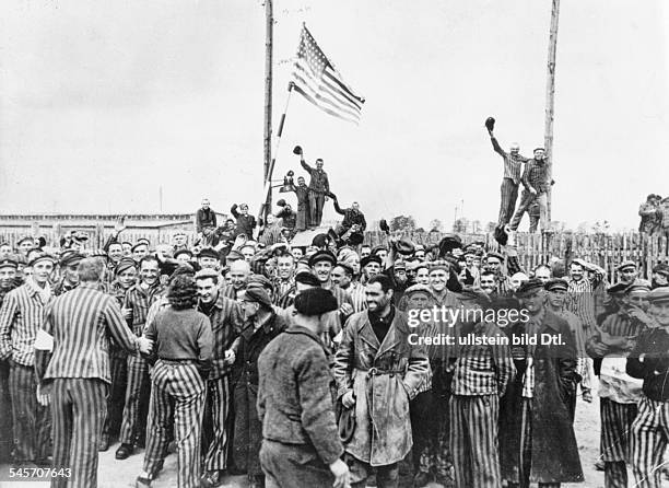 Germany, Third Reich - concentration camps 1939-45 Detainees from Dachau concentration camp gathering on the former place of roll call after the...