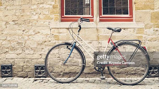 bicycle leaning against old wall, vintage - traditionally hungarian fotografías e imágenes de stock