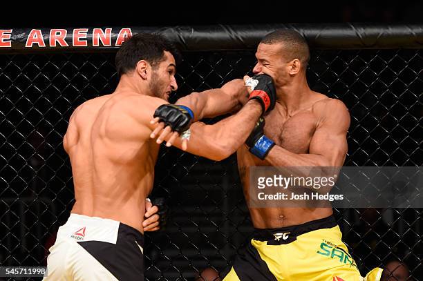 Gegard Mousasi of The Netherlands punches Thiago Santos of Brazil in their middleweight bout during the UFC 200 event on July 9, 2016 at T-Mobile...