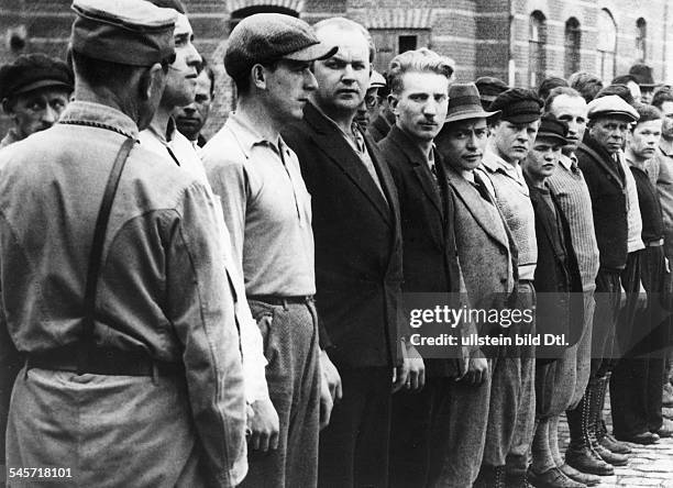 Reich - persecution of political enemies: 1933-39: SA sentinels calling the roll at Oranienburg concentration camp . April 1933 .