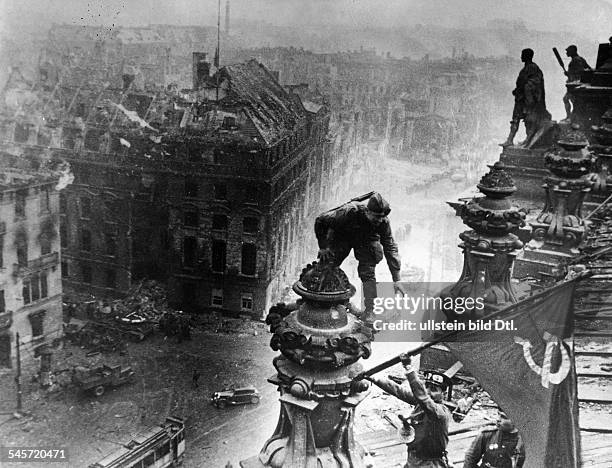 The Russian soldiers Jegorow and Kantarija hoisting the Soviet Flag on the destroyed Reichstag building - May 1945 Picture taken by J. Cheldej. Also...
