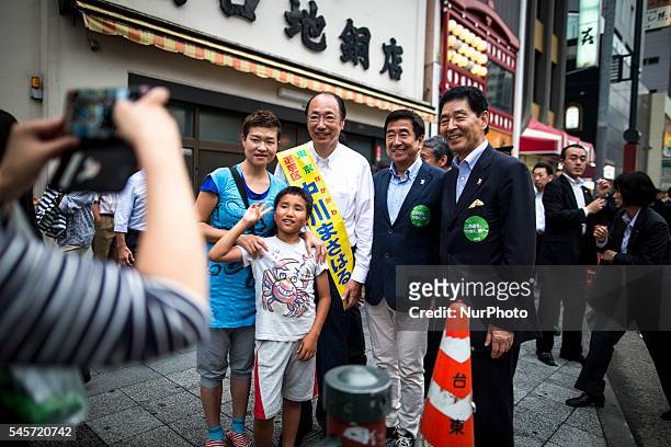 Masaharu Nakagawa a candidate from Liberal Democratic Party take photos with supporters during the last day of 2016 Upper House election campaign...
