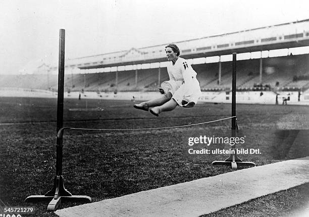 Track and field athletics, women high jump: a Swedish athlete jumps across a rope, in the background the empty seats of the White City Stadium in...