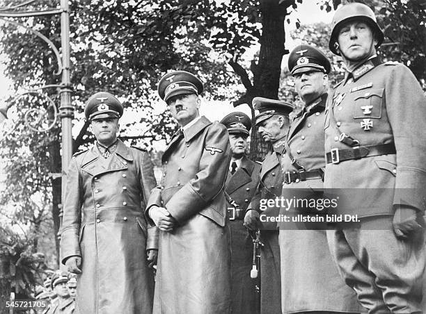 Stand during the victory parade of the Wehrmacht at Ujazdów Avenue in Warsaw;next to Adolf Hitler, from the l: Field Marshal Walther von Brauchitsch,...