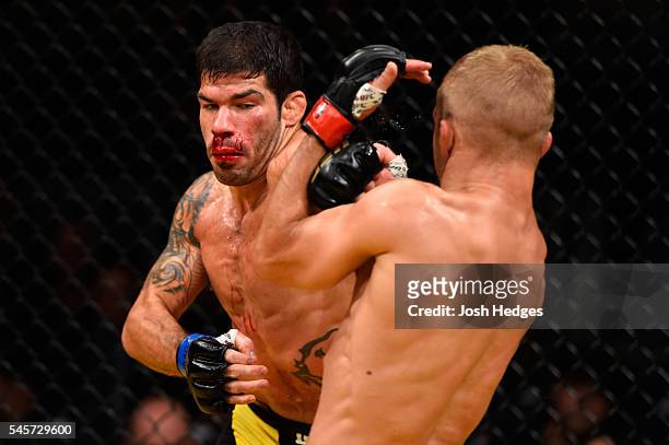 Raphael Assuncao of Brazil punches TJ Dillashaw in their bantamweight bout during the UFC 200 event on July 9, 2016 at T-Mobile Arena in Las Vegas,...