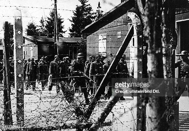 Scene from the movie 'Long is the way':Transport of prisoners under guardin a concentration camp