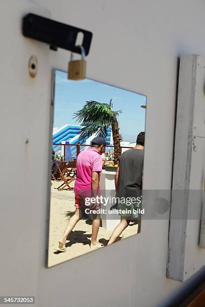 Belgium Flanders - Knokke-Heist: people in a mirror of a changing room of the private beach 'Viaene'