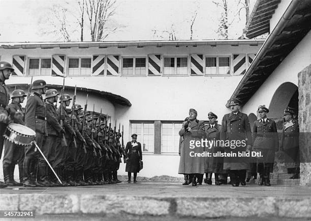 Adolf Hitler and Italian leader Benito Mussolini are taking the salute of a guard of honour of the Leibstandarte SS Adolf Hitler in front of the...
