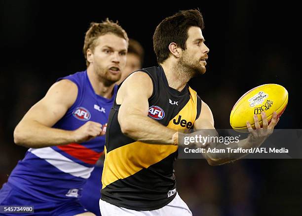 Trent Cotchin of the Tigers handpasses the ball during the 2016 AFL Round 16 match between the Western Bulldogs and the Richmond Tigers at Etihad...