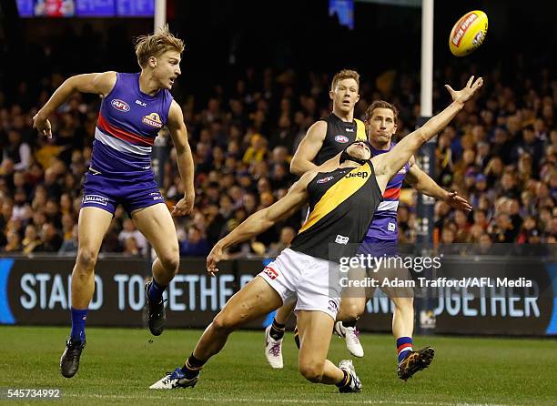 Ben Griffiths of the Tigers attempts to mark ahead of Shane Biggs of the Bulldogs during the 2016 AFL Round 16 match between the Western Bulldogs and...