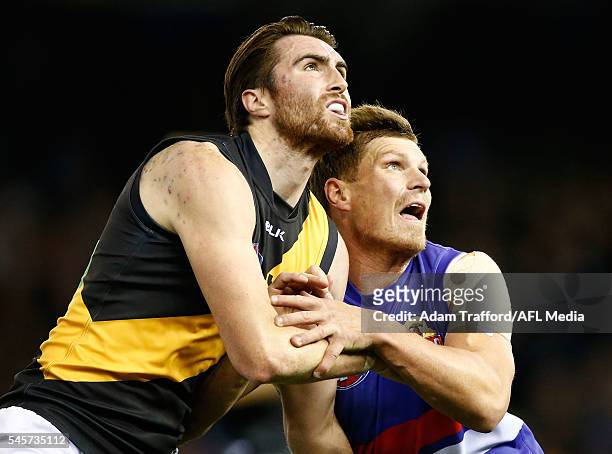 Liam McBean of the Tigers and Jack Redpath of the Bulldogs compete in a ruck contest during the 2016 AFL Round 16 match between the Western Bulldogs...