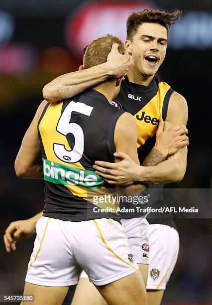 Brandon Ellis of the Tigers celebrates a goal with Oleg Markov of the Tigers during the 2016 AFL Round 16 match between the Western Bulldogs and the...