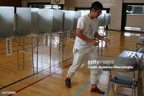 An eighteen year old young man cast his vote for parliament's upper house election at a polling station on July 10, 2016 in Himeji, Japan. Japan went...