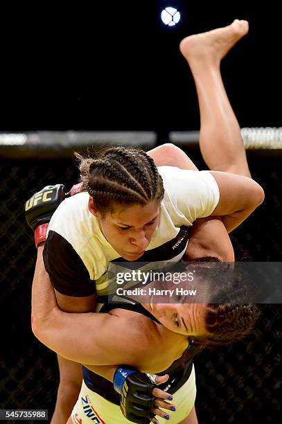 Cat Zingano wrestles with Julianna Pena in their women's bantamweight bout during the UFC 200 event on July 9, 2016 at T-Mobile Arena in Las Vegas,...