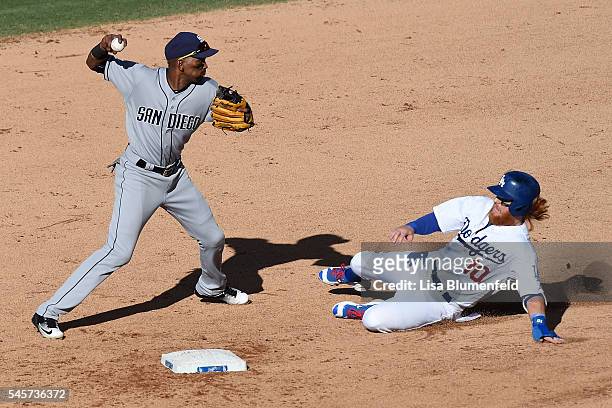 Justin Turner of the Los Angeles Dodgers is an out at second base in the fifth inning against Alexei Ramirez of the San Diego Padres at Dodger...
