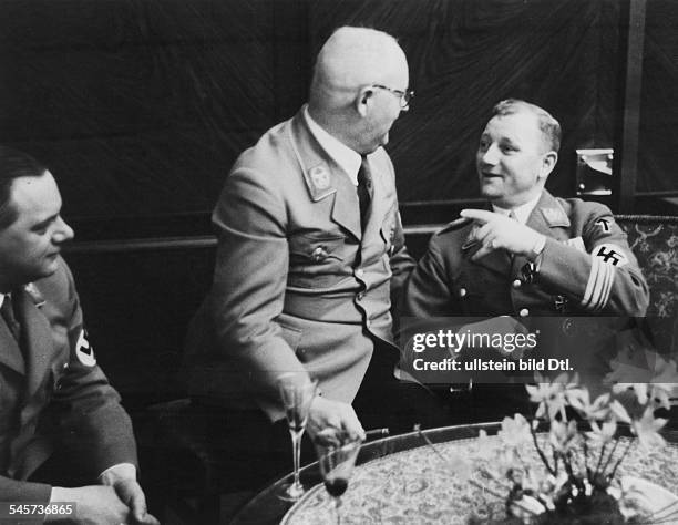 Germany Third Reich Reception at the 'Fuehrerbau' on the Koenigsplatz in Munich: SA Chief of Staff Victor Lutze talking to Reich treasurer Franz...