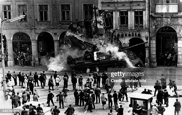 Prague Spring - Suppression Invasion of Czechoslovakia by troops of the Warsaw Pact countries| a Soviet tank is driving into the facade of a building...