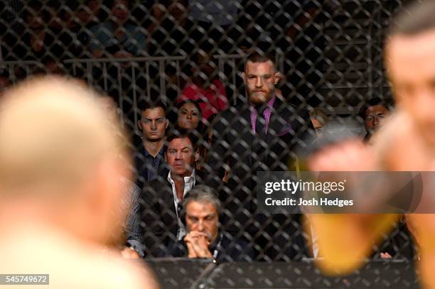 Featherweight champion Conor McGregor watches Jose Aldo of Brazil vs Frankie Edgar in their UFC interim featherweight championship bout during the...