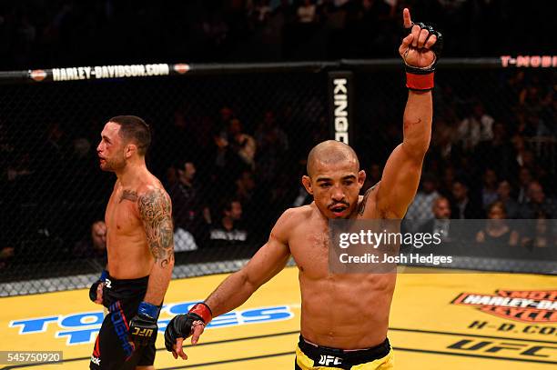 Frankie Edgar and Jose Aldo of Brazil react after their UFC interim featherweight championship bout during the UFC 200 event on July 9, 2016 at...