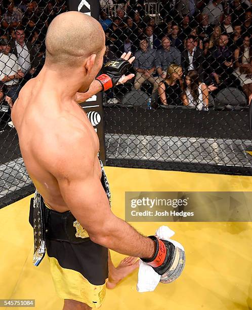 Jose Aldo of Brazil speaks to Conor McGregor after defeating Frankie Edgar in their UFC interim featherweight championship bout during the UFC 200...