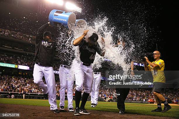 Tyler Anderson of the Colorado Rockies gets a shower from teammates Jason Motte and Brandon Barnes after leading the team to the win against the...