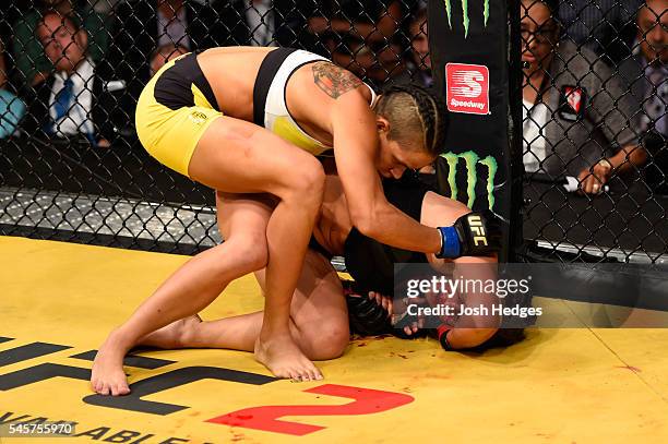 Amanda Nunes of Brazil grapples with Miesha Tate in their UFC women's bantamweight championship bout during the UFC 200 event on July 9, 2016 at...