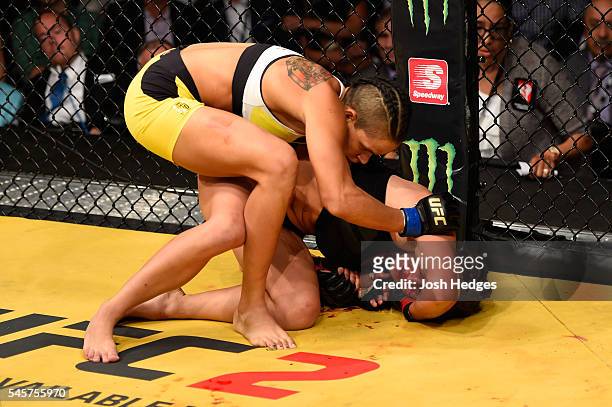 Amanda Nunes of Brazil grapples with Miesha Tate in their UFC women's bantamweight championship bout during the UFC 200 event on July 9, 2016 at...