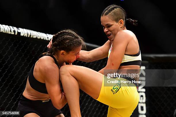 Amanda Nunes of Brazil knees Miesha Tate in their UFC women's bantamweight championship bout during the UFC 200 event on July 9, 2016 at T-Mobile...