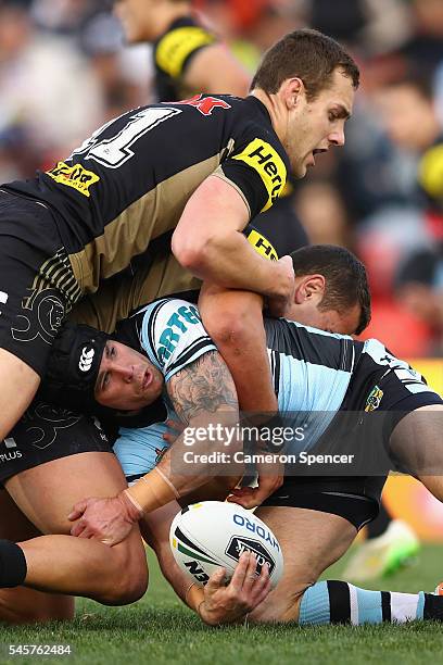 Michael Ennis of the Sharks is tackled during the round 18 NRL match between the Penrith Panthers and the Cronulla Sharks at Pepper Stadium on July...