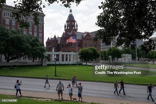 The American flag flies at half staff as visitors explore Dealey Plaza in Dallas, TX, on July 9, 2016. Pres. John F. Kennedy was assassinated in this...