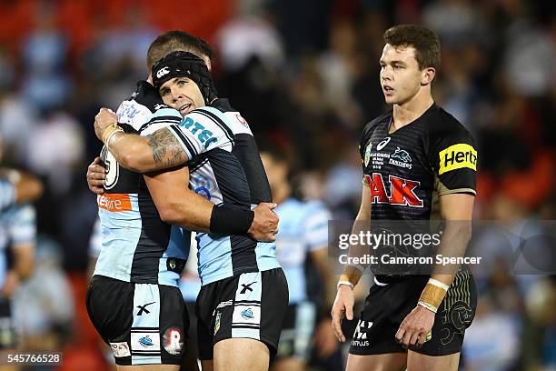 Michael Ennis of the Sharks and Chris Heighington of the Sharks embrace after winning the round 18 NRL match between the Penrith Panthers and the...