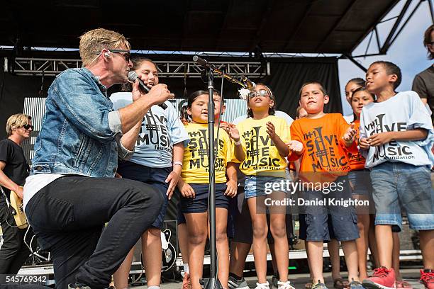 Musician Jon Foreman of Switchfoot performs on stage with a group of children from the VH1 Save The Music Foundation at Moonlight Beach on July 9,...