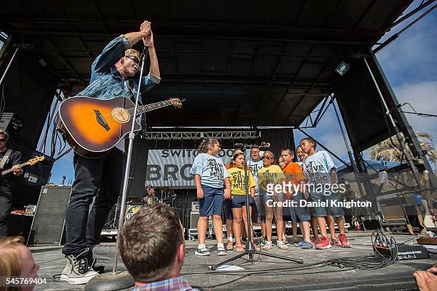 Musician Jon Foreman of Switchfoot performs on stage with a group of children from the VH1 Save The Music Foundation at Moonlight Beach on July 9,...