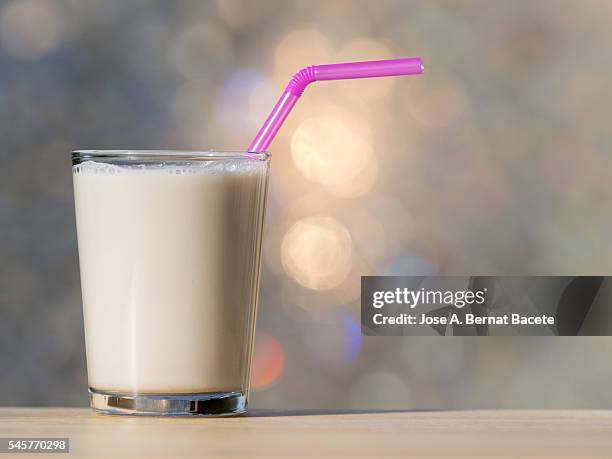 glass of horchata of chufa, on a table lit by sunlight - filling jar stock pictures, royalty-free photos & images